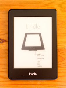 Amazon Kindle em cima de uam superfície de madeira avermelhada