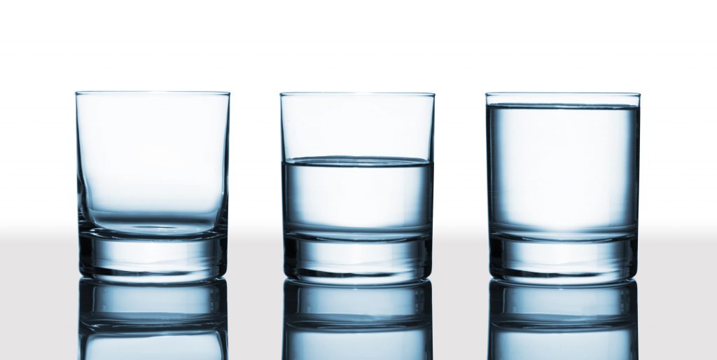 copo vazio, meio cheio e outro cheio com água