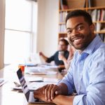 homem sorrindo para ilustrar texto sobre ser importante ter pós-graduação