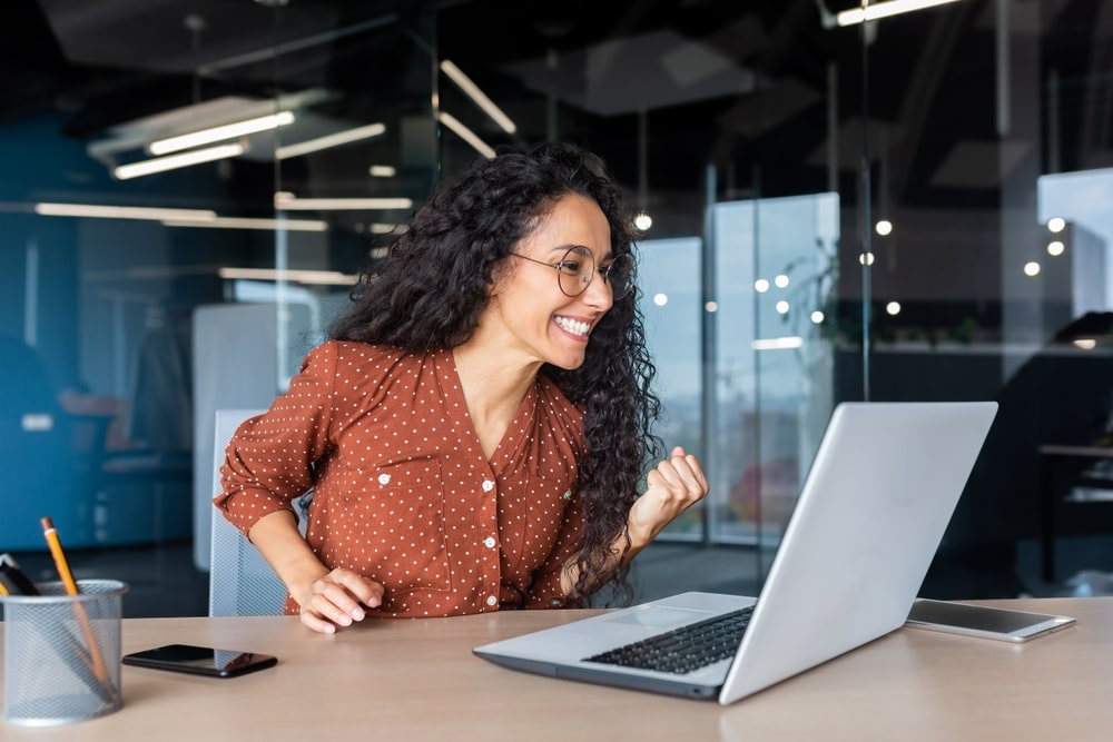 mulher comemorando para ilustrar texto sobre o que te move no trabalho