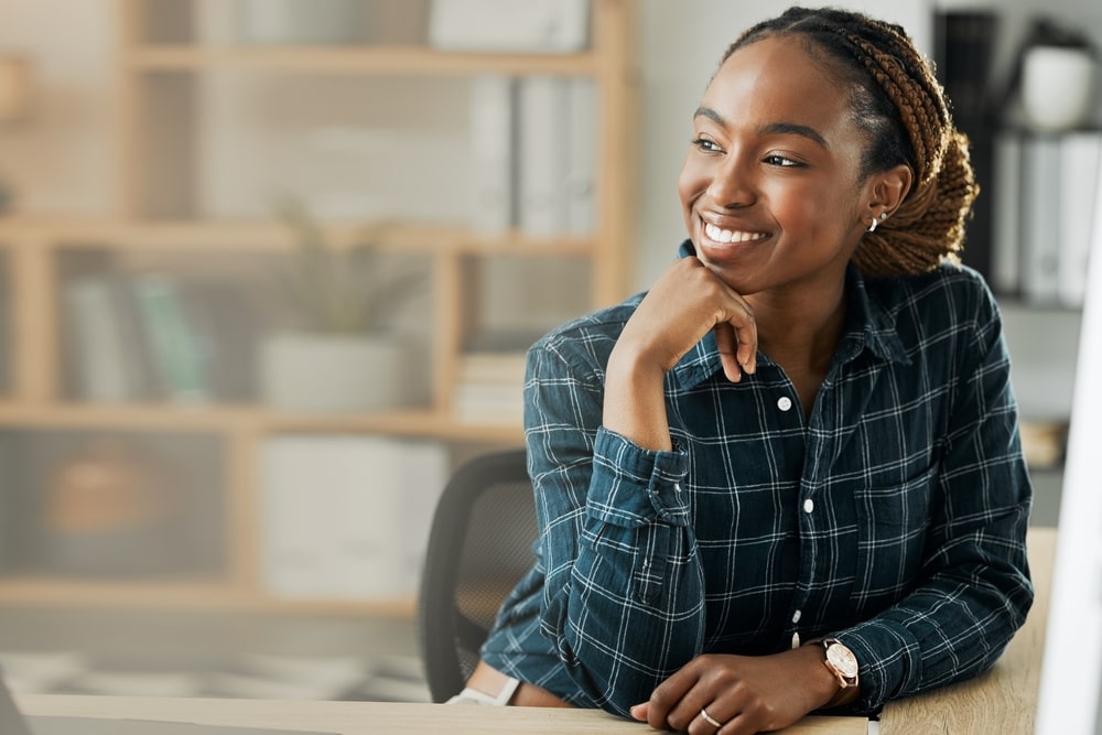 mulher sorrindo no trabalho para ilustrar texto sobre qual a importância do marketing pessoal