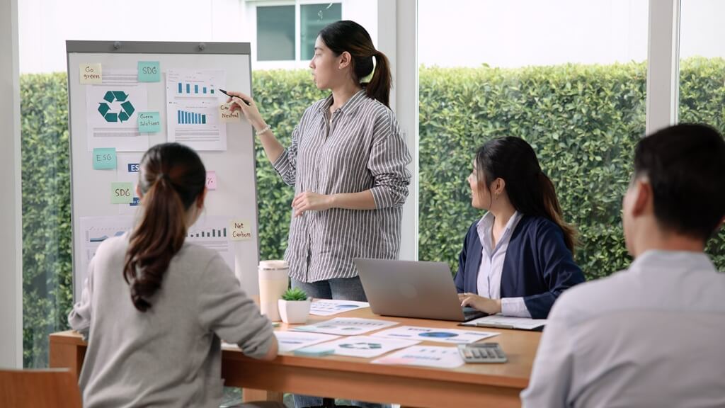 mulher explicando gráfico para equipe